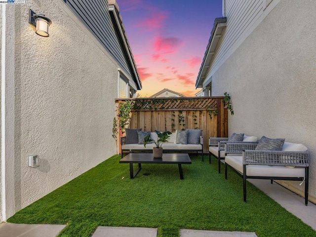 yard at dusk with an outdoor hangout area