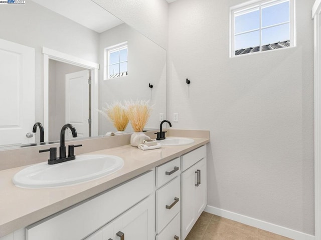 bathroom with tile patterned flooring and vanity