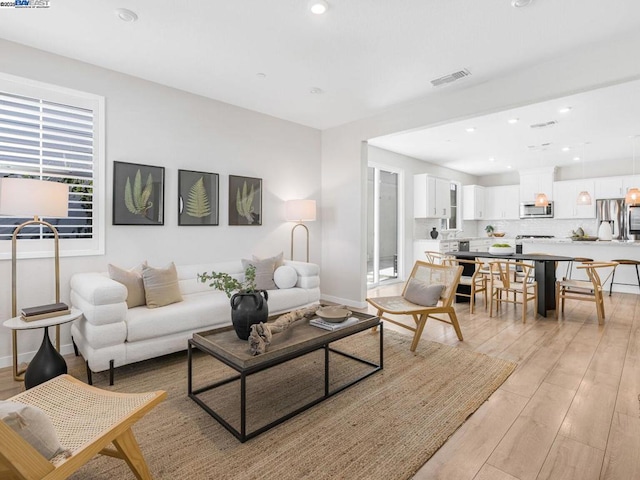 living room with light hardwood / wood-style flooring