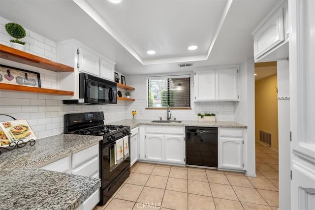 kitchen with black appliances, sink, tasteful backsplash, and white cabinetry