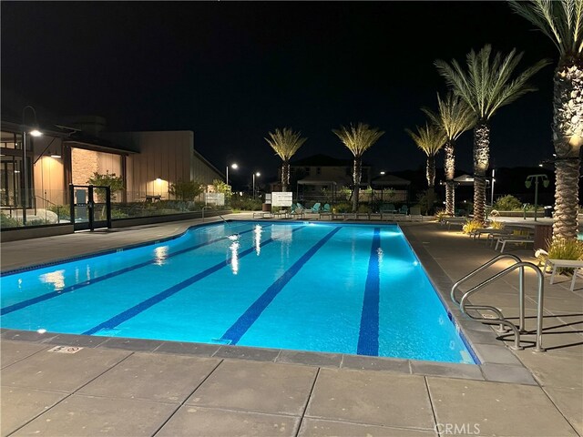 pool at twilight with a patio