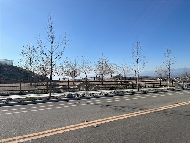 view of road featuring sidewalks and a mountain view