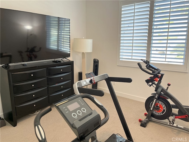 workout area featuring light colored carpet