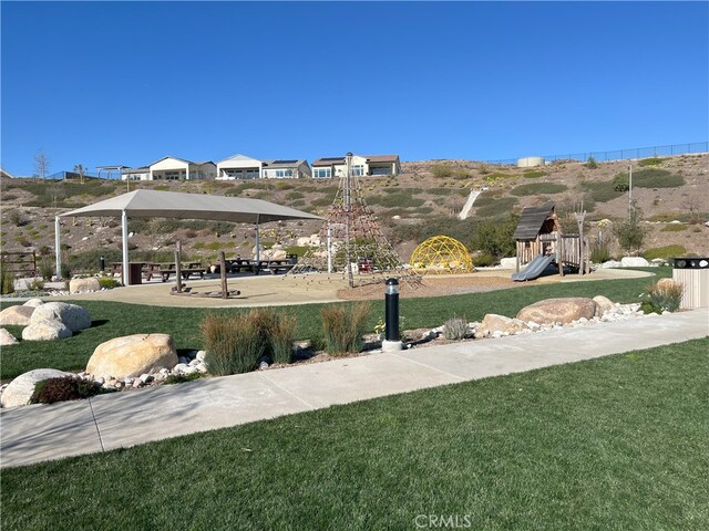 surrounding community with a playground and a lawn