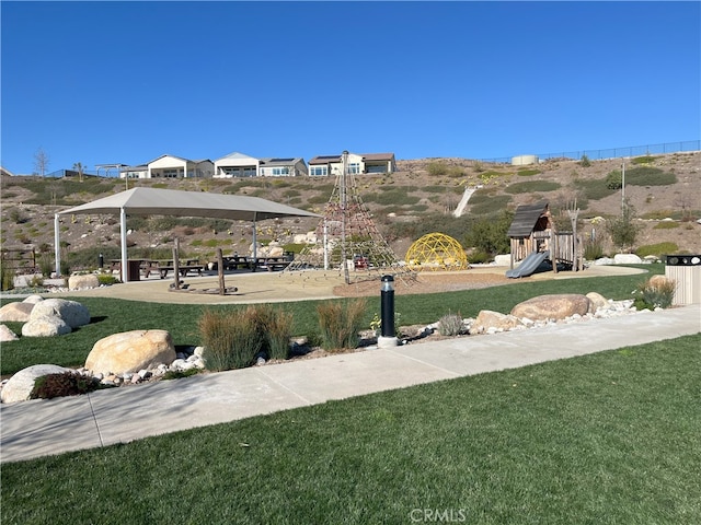 view of community with playground community and a yard