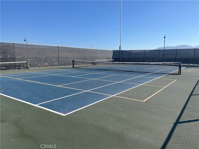 view of tennis court with fence