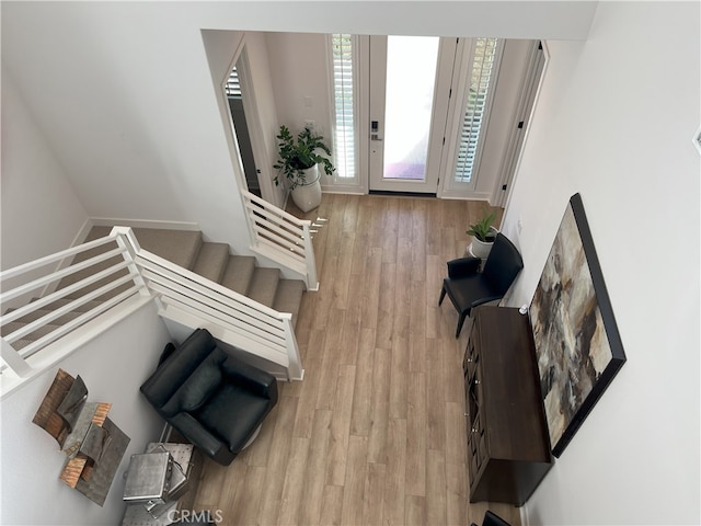 entryway with stairway and light wood-style flooring