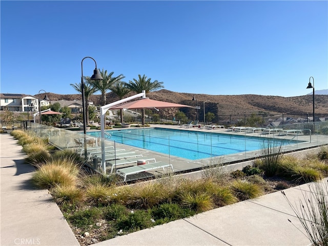 view of swimming pool with a mountain view