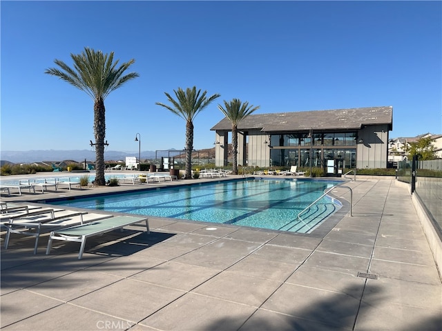 view of pool featuring a patio area and a mountain view