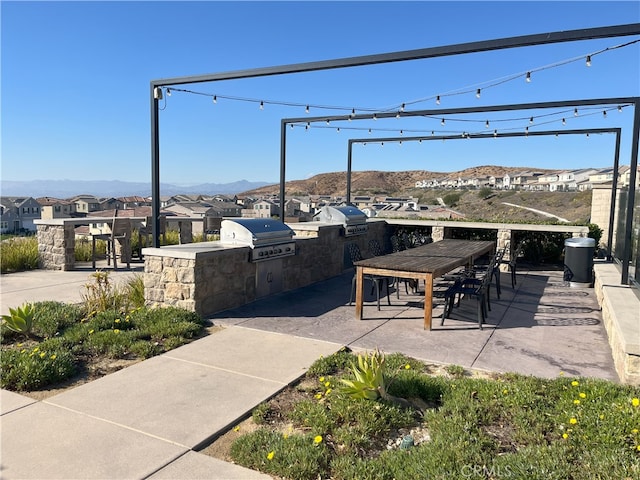 view of patio featuring a mountain view, grilling area, and area for grilling