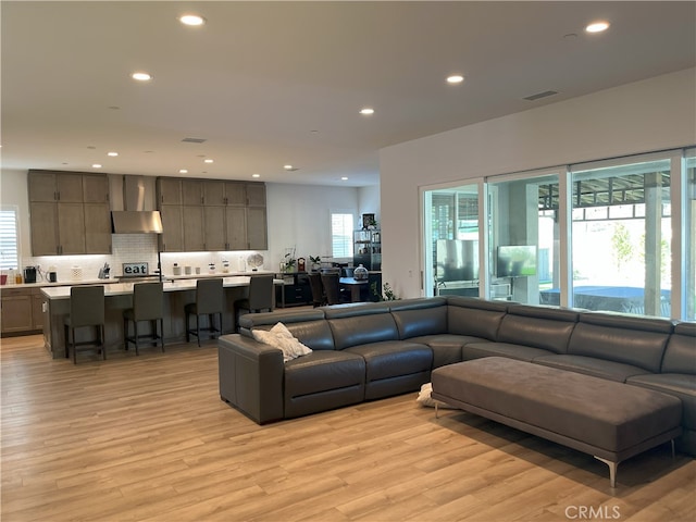 living room featuring plenty of natural light and light hardwood / wood-style flooring