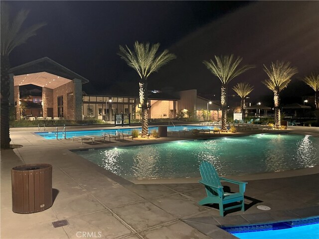 pool at twilight with a patio