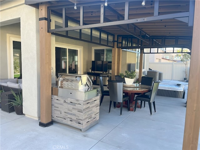 view of patio featuring outdoor dining area, fence, and an outdoor kitchen