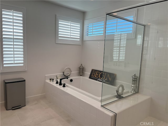 bathroom featuring tile patterned flooring, a wealth of natural light, and independent shower and bath