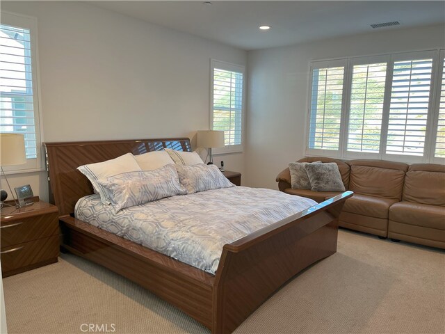 carpeted bedroom with wood walls