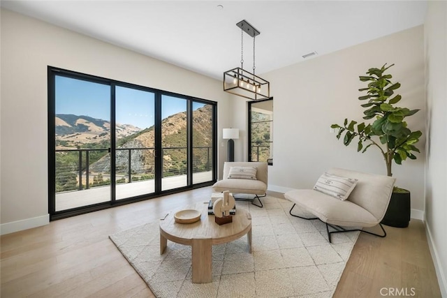 living area featuring light wood-type flooring and a mountain view