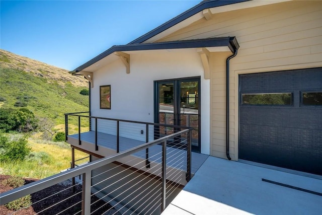 exterior space with a balcony and a garage