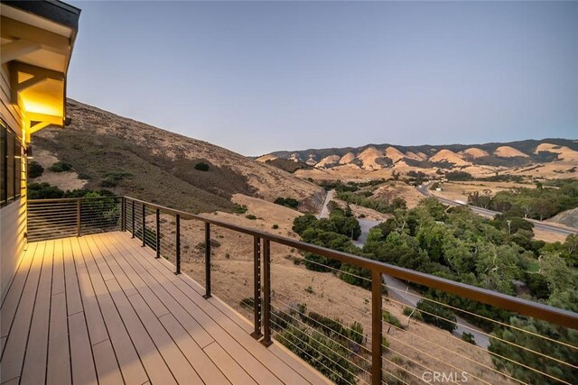 wooden deck featuring a mountain view