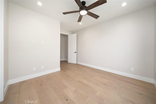 spare room featuring light hardwood / wood-style floors and ceiling fan