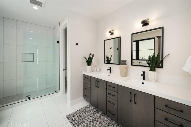 bathroom with toilet, tile patterned flooring, a shower with shower door, and vanity