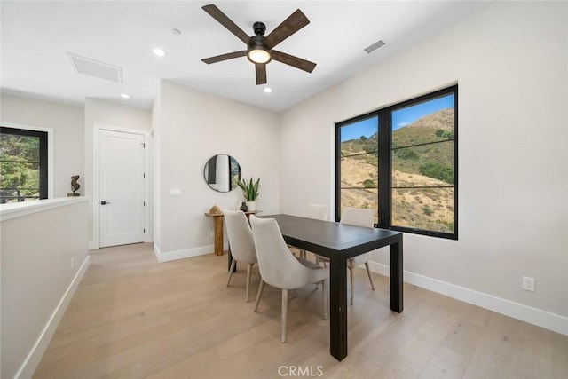 dining space featuring ceiling fan and light wood-type flooring