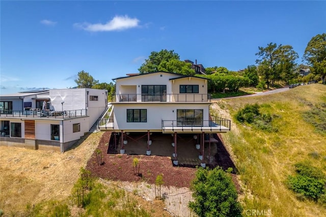 rear view of property with a balcony