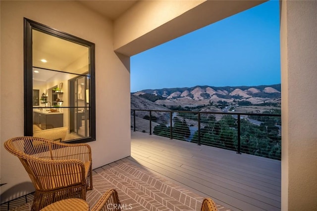 balcony at dusk with a mountain view