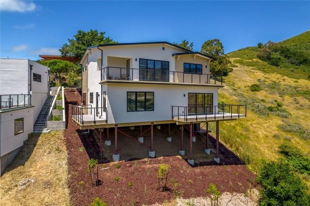 rear view of property with a balcony