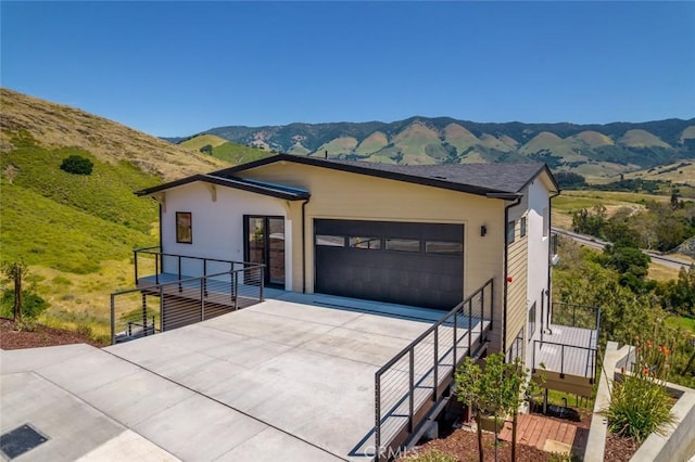 view of front facade featuring a mountain view and a garage