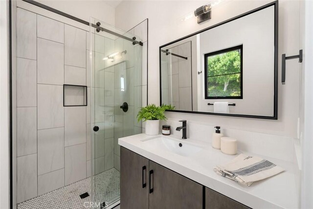 bathroom with walk in shower and vanity