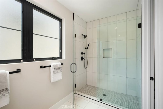 bathroom featuring a shower with shower door and tile patterned flooring