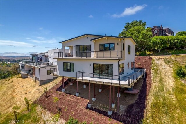 rear view of property with a balcony