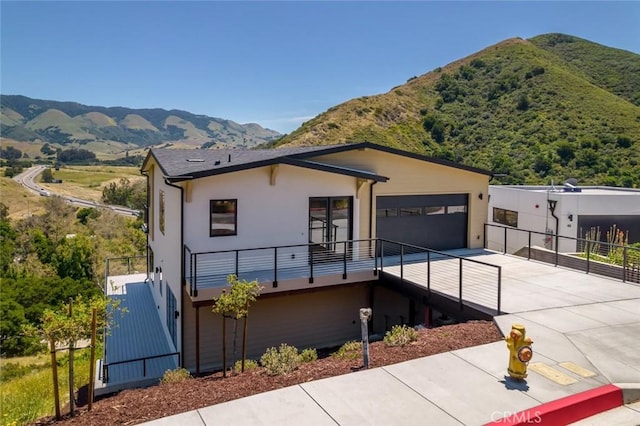 view of front of property with a mountain view and a garage