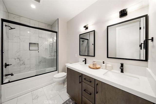 full bathroom featuring enclosed tub / shower combo, vanity, and toilet