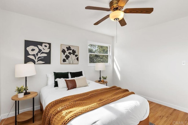 bedroom with ceiling fan and wood-type flooring