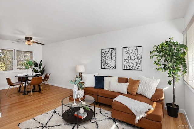 living room featuring hardwood / wood-style flooring and ceiling fan