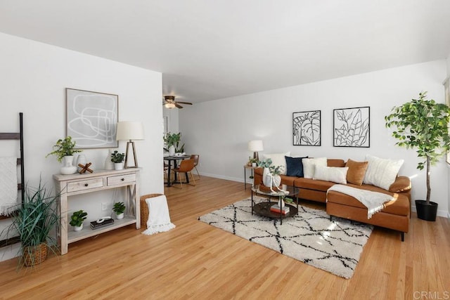 living room with light wood-type flooring and ceiling fan