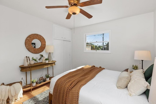 bedroom with ceiling fan and hardwood / wood-style flooring