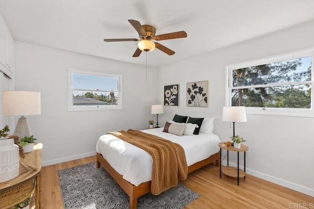 bedroom with ceiling fan and light hardwood / wood-style flooring