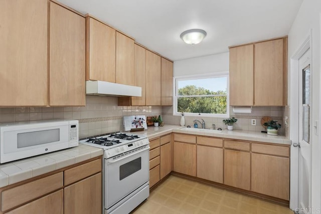 kitchen with tasteful backsplash, sink, white appliances, ventilation hood, and light brown cabinetry