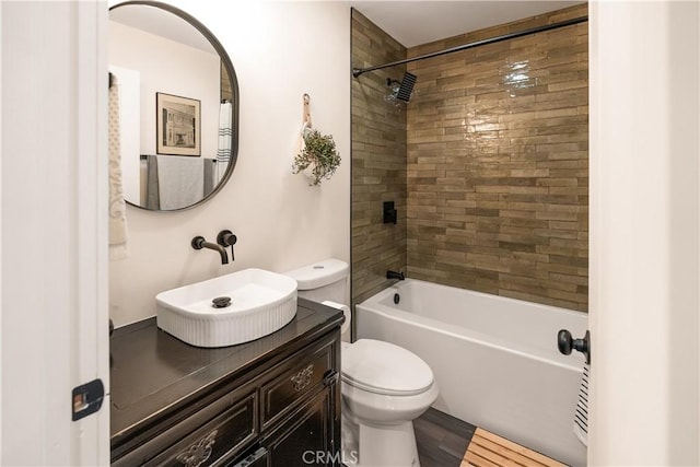 full bathroom with vanity, toilet, and tiled shower / bath combo