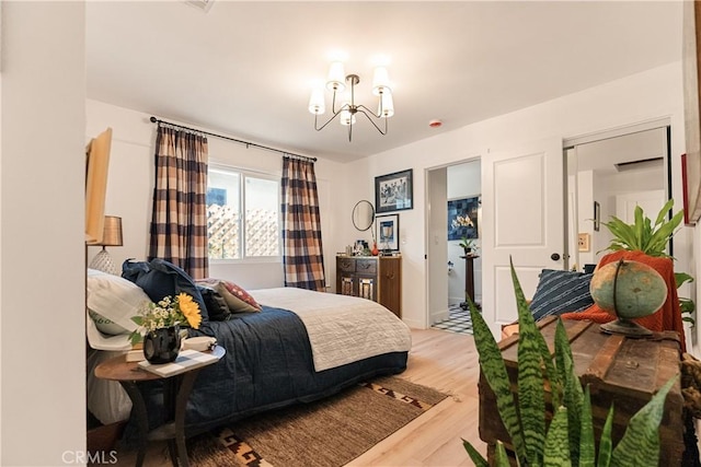 bedroom featuring an inviting chandelier and hardwood / wood-style flooring