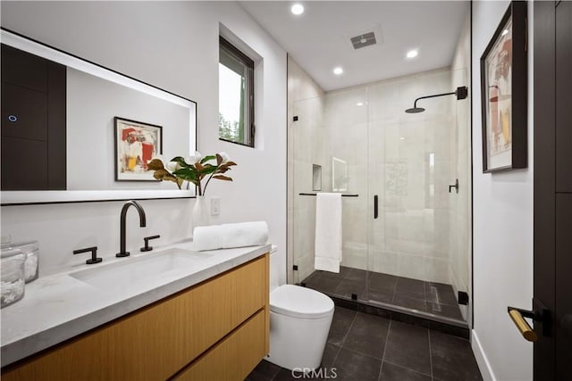 bathroom with toilet, tile patterned floors, walk in shower, and vanity