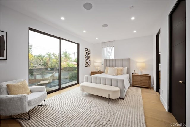 bedroom with access to exterior and light hardwood / wood-style flooring