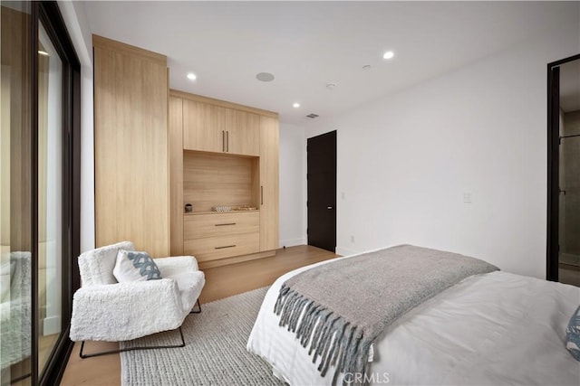 bedroom with light hardwood / wood-style floors