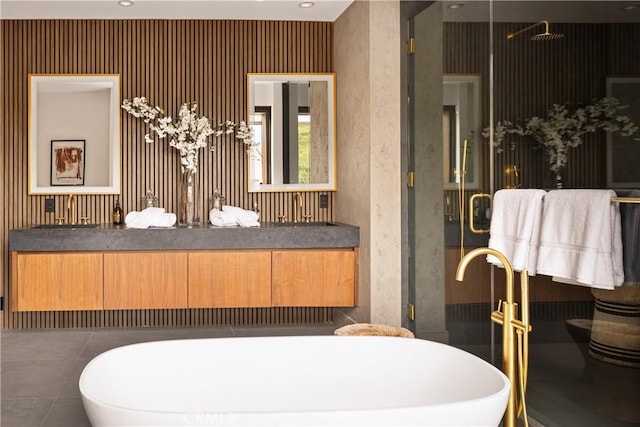 bathroom featuring a shower with shower door and vanity