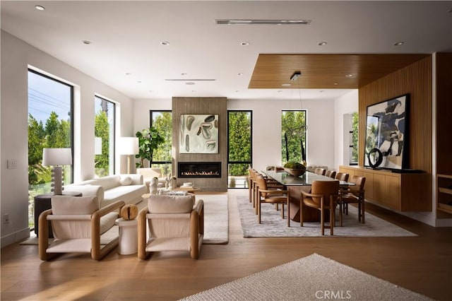 interior space with a wealth of natural light, a fireplace, and hardwood / wood-style floors