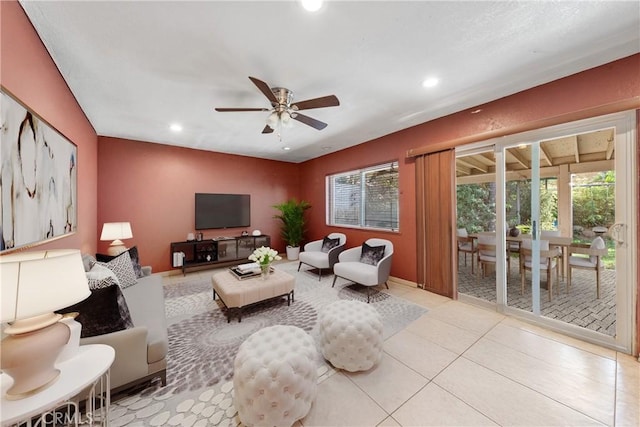 living room with ceiling fan and light tile patterned flooring