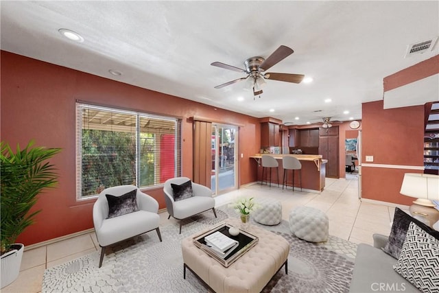 living room featuring ceiling fan and light tile patterned floors