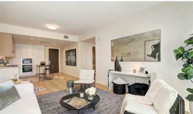 living room with light hardwood / wood-style flooring